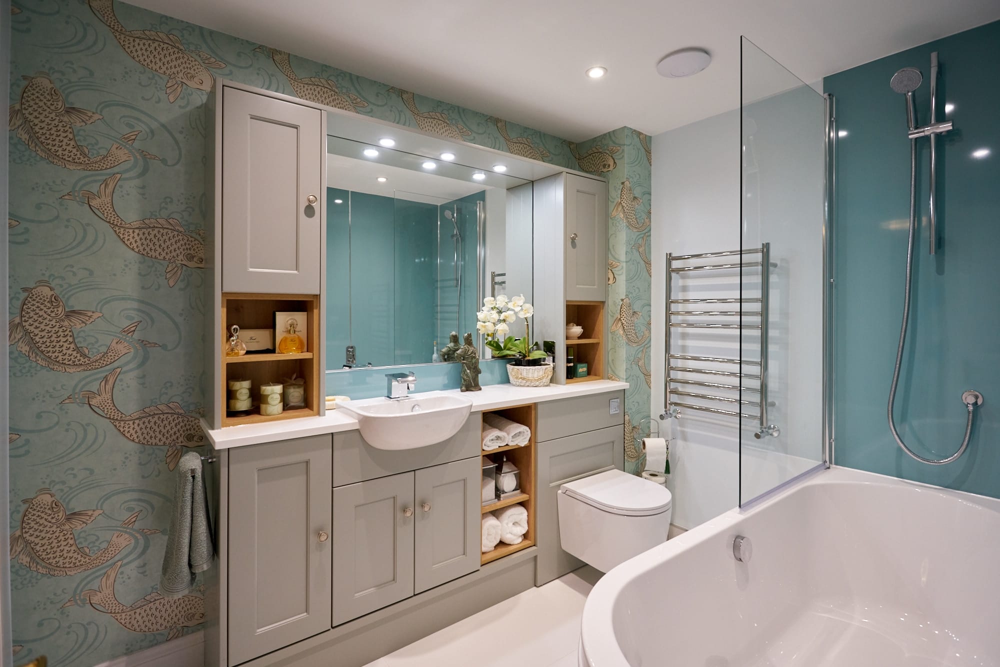 A modern bathroom featuring stylish cabinetry, a shower, and decorative fish wallpaper.