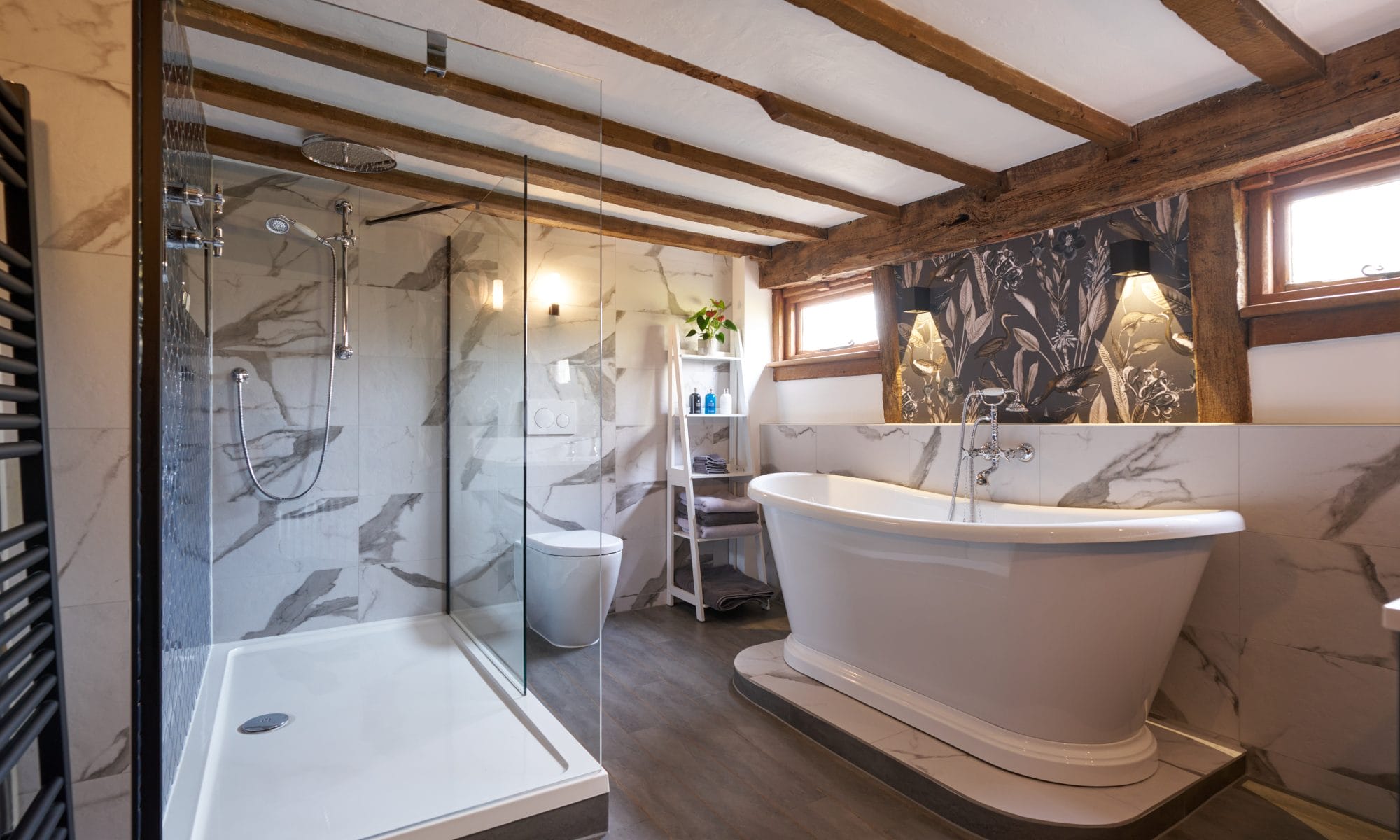 Bathroom Design with Boat Bath on Plinth with feature wallpaper