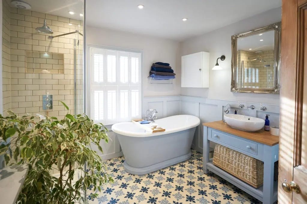 luxury bathroom with encaustic patterned floor and shaker style wood panelling
