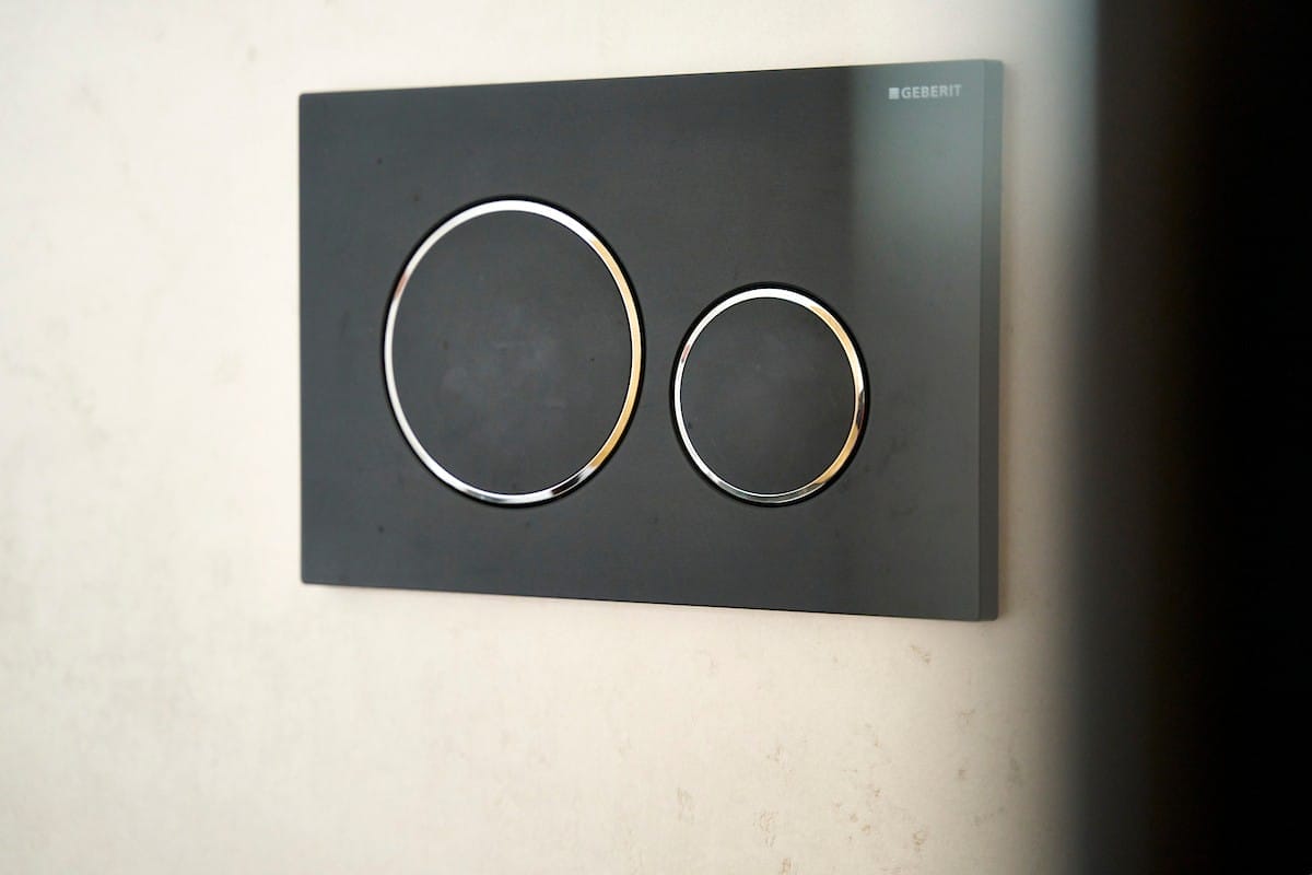 geberit flush plate in black with round buttons